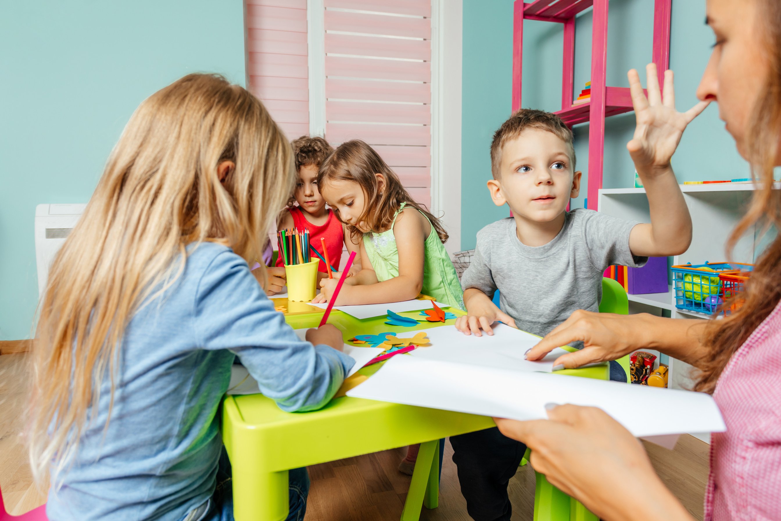 Preschool Boy Demands Teacher's Attention during Art Lesson